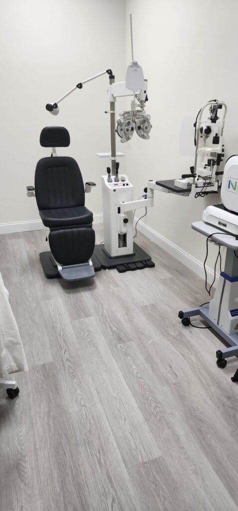 Exam room at Reel Optics with exam chair and eye testing equipment