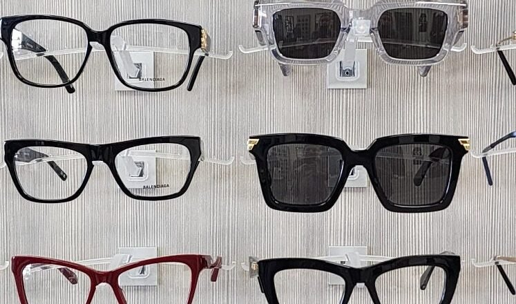 Wall of eyeglass frames with a Bottega Veneta display at Reel Optics