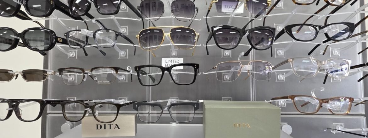 Wall of designer frames with Dita cases on the shelf at Reel Optics