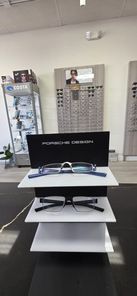 Porsche Design frames on a display stand with a Costa display case behind